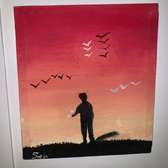 Tableau bonhomme sous un coucher du soleil avec son chaton