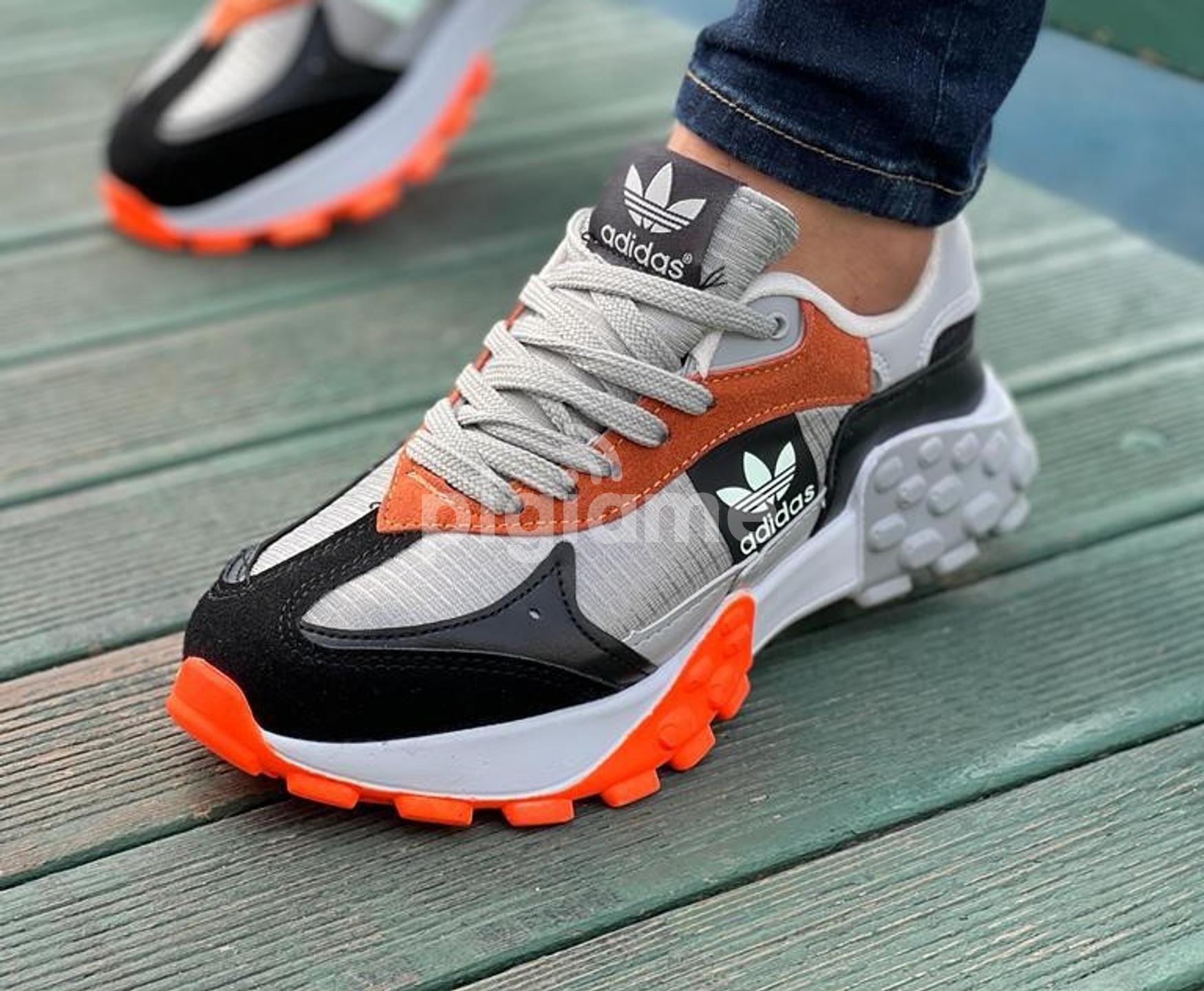 Orange addidas trainers top