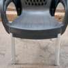 Plastic chair with metallic tubing legs. thumb 1