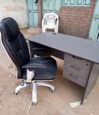 Grey desk with a leather chair