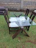 A modern and elegant 4-seater dining set, with glass top