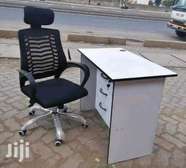 Grommeted office desk with a headrest chair