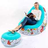 Portable inflatable seat with foot rest and manual pump