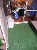 relaxing balcony well fitted with artificial grass carpet
