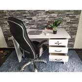 White office table with an adjustable leather chair