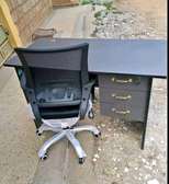Home office table and a swivel adjustable chair