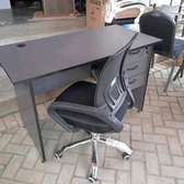 Office chair with curved ergonomic back plus a writing table