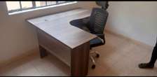 L shaped desk with a headrest chair