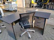 L shaped office desk with a mesh chair