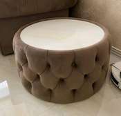 Buttoned round glass top ottoman table