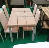 White dining table with four dining chairs
