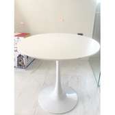 white simple round dining table with a round base