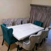 White wooden dinning table with 8 chairs
