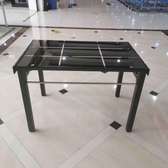 Glass top dining table with rubber legs