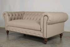 Modern beige three seater chesterfield sofa