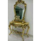 Golden antique console tables with wall mirrors