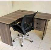 L shaped office desk with a laptop chair