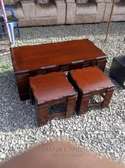 a classy and luxurious coffee table with two stools