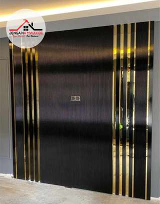 Black flutted panels with gold strip tape interior design image 3