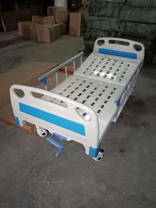 single crank hospital bed with mattress and drip stand image 2
