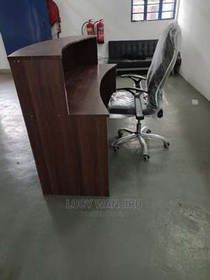 Reception desk with a leather chair image 1