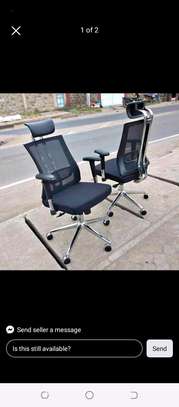 Office high back chair with a metallic back support image 1