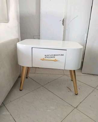 Modern bedside cabinet with gold carrot shaped stand image 1