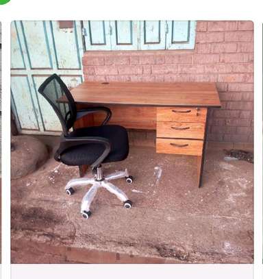 Modern office table with drawers and a secretarial chair image 1