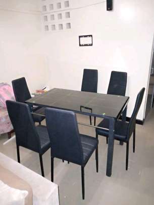 Dining table with leather seats image 1