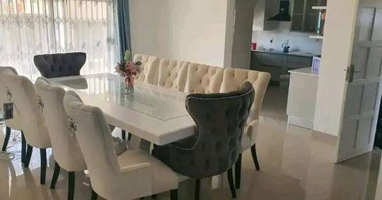 Glass top dining table with 8 chairs image 1