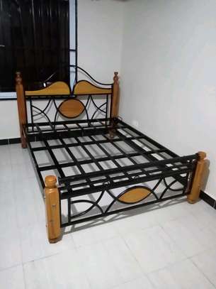 Bed design size 5by 6 wooden with metal and wood mahogany image 1