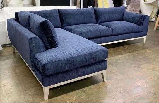L shape sofa with bouncy cushions and lower wooden skirting image 1