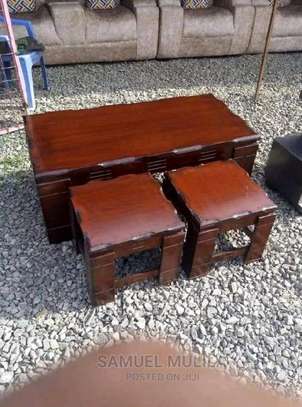 a classy and luxurious coffee table with two stools image 1