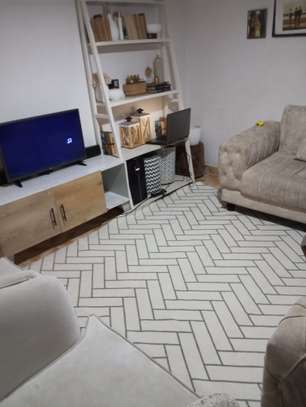 8.2 by 6.8 white carpet with herringbone print. image 1