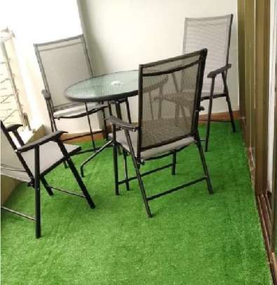 A verdant relaxing area fitted with artificial grass carpet image 2