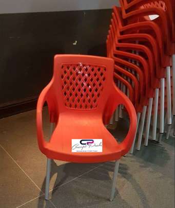 Plastic chair with metallic tubing legs. image 1