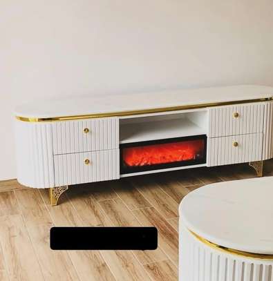 Elegant White TV Stand with Gold Trim & Fireplace image 2