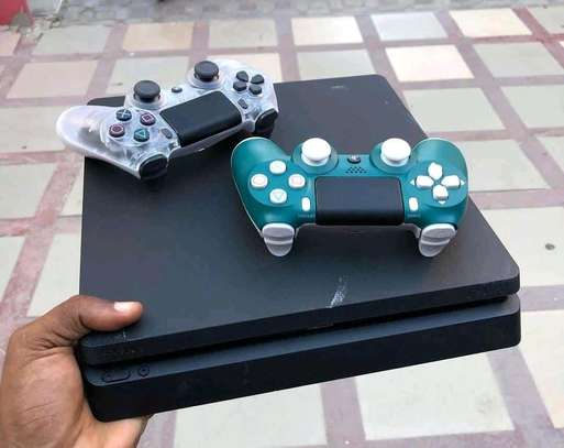 Playstation 4 slim available in mint condition image 1