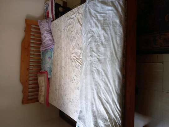 Queen size bed with mattress and pillow image 2