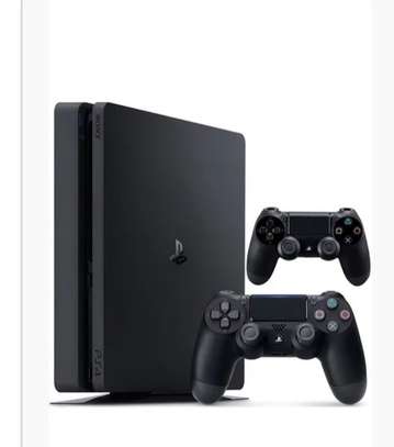 PS4 slim with 2 controllers and red dead redemption 2 image 1