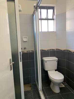 3 bedroom apartment master Ensuite with a cloakroom image 7