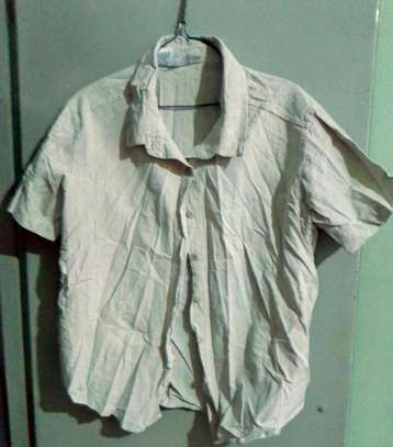 Beige button down shirt. image 2