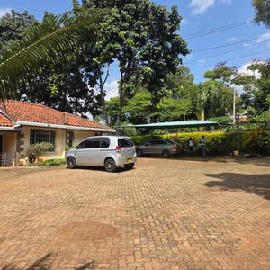 Stunning Modern 5-Bedroom Unfurnished Bungalow To Let – Kyuna, Nairobi

Experience refined living in this stunning and spacious 5-bedroom unfurnished bungalow, ideally located in the prestigious and tranquil neighborhood of Kyuna. Designed with elegance, comfort, and security in mind, this exceptional home offers generous living spaces, high-quality finishes, and a serene garden setting.

The property features a bright and spacious living room with a cozy fireplace that opens onto a balcony overlooking the beautifully landscaped garden, creating the perfect space for relaxation or entertaining. A separate dining area complements the modern kitchen, which comes with a pantry and a dedicated laundry area for added convenience.

The home boasts five well-proportioned bedrooms, including a huge master bedroom with a modern en-suite bathroom. Additional features include a guest cloakroom, stylish bathrooms, premium wooden and tiled flooring, excellent finishes throughout, and a safe haven for enhanced security and peace of mind.

Outside, the property sits on a beautifully maintained compound with a lush garden adorned with mature trees, ample parking, and a secure perimeter wall topped with an electric fence. The residence benefits from UN-approved security, making it an ideal choice for diplomats, expatriates, and families seeking a safe and prestigious address.

Property Features:

5 spacious bedrooms
Guest cloakroom
Spacious living room with fireplace
Balcony overlooking the garden
Separate dining area
Modern kitchen with pantry
Laundry area
Huge master bedroom with modern en-suite bathroom
High-quality wooden and tiled flooring
Excellent modern finishes
Safe haven
Beautiful landscaped garden with mature trees
Ample parking
Perimeter wall with electric fence
UN-approved security

This elegant bungalow offers the perfect blend of luxury, privacy, and convenience in one of Nairobi's most sought-after residential neighborhoods.