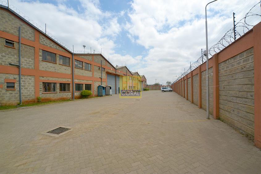 Warehouse with Electric Fence in Industrial Area