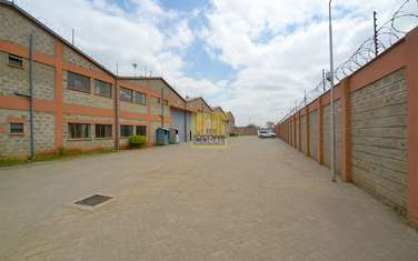 Warehouse with Electric Fence in Industrial Area