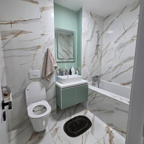 Apartament modern cu 3 camere, balcon generos și parcare subterană.